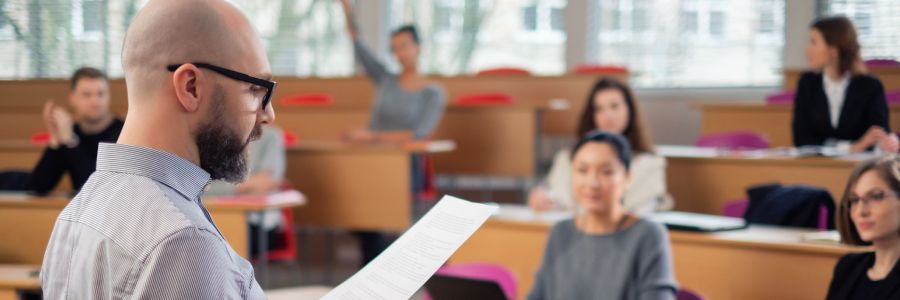 An instructor delivering his entrepreneurship curriculum to a university business class.