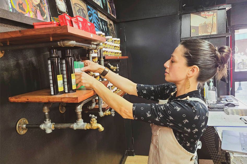 Kristen Fischer organizing hair products in her barbershop