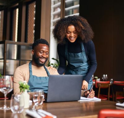 Man and woman working on laptop