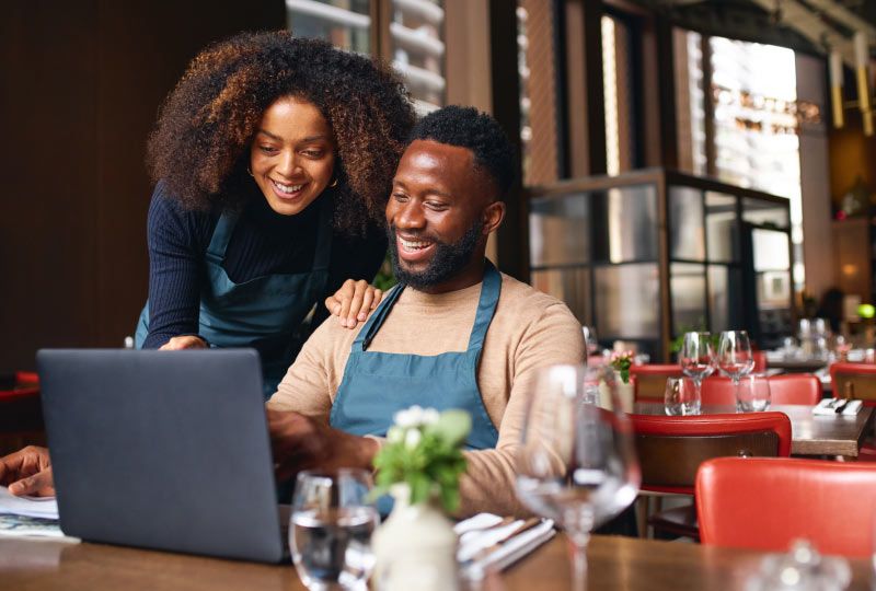 Man and woman working on laptop