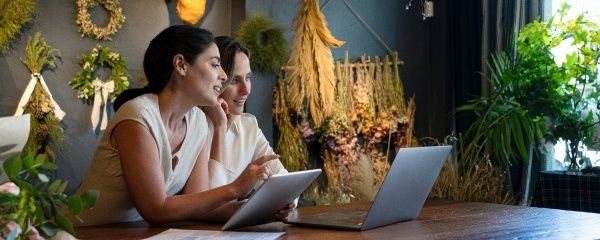 A couple in front of a laptop and tablet reviewing videos and resources