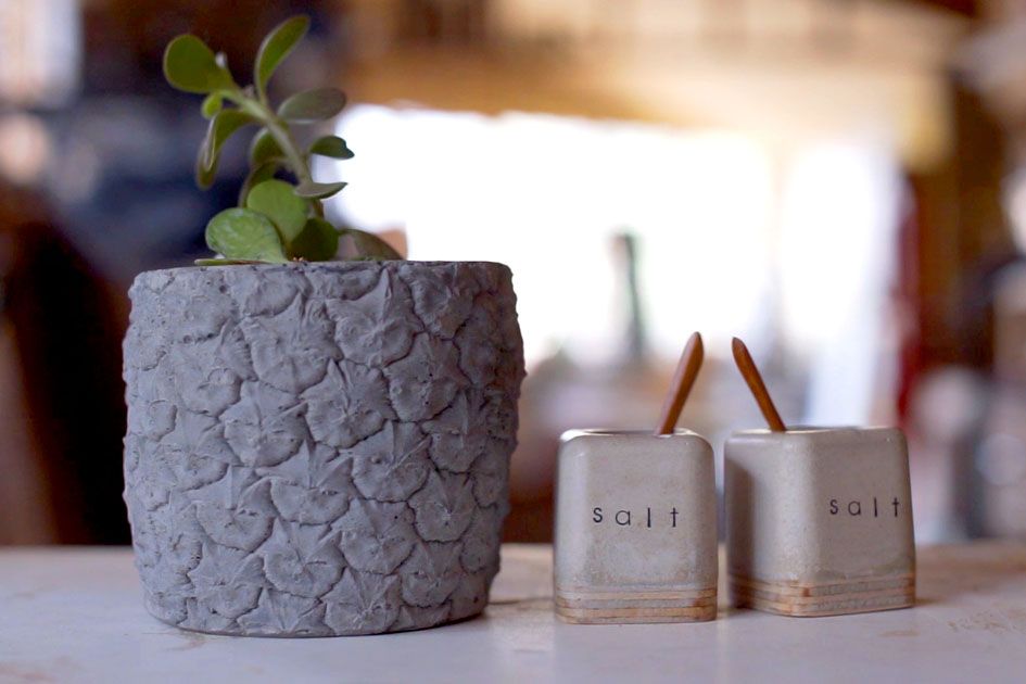 Several of Mona Patel's concrete housewares including a flower pot and two salt shakers