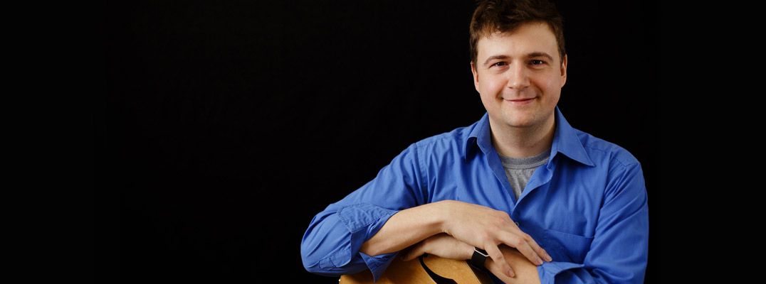 Marc-Andre Seguin posing with a guitar in his studio