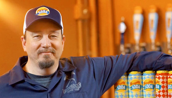 David Sheets posing with several cans of Naughty Soda