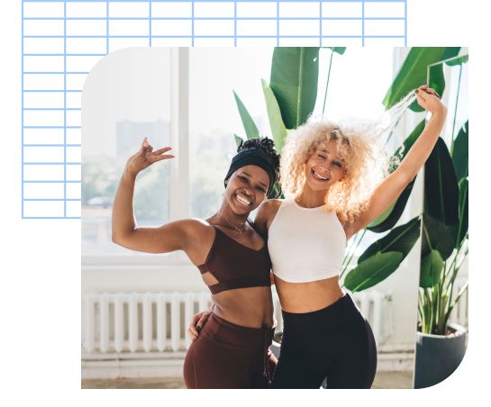 Two people celebrating after their yoga session