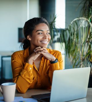 Smiling woman using laptop