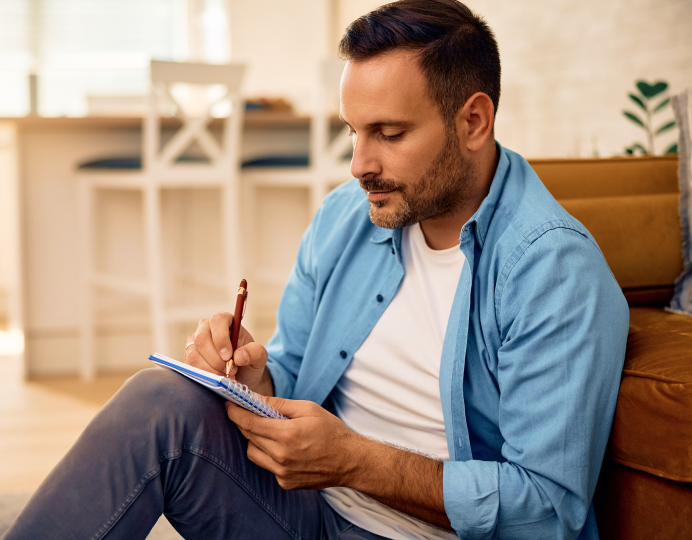 Person writing on notepad